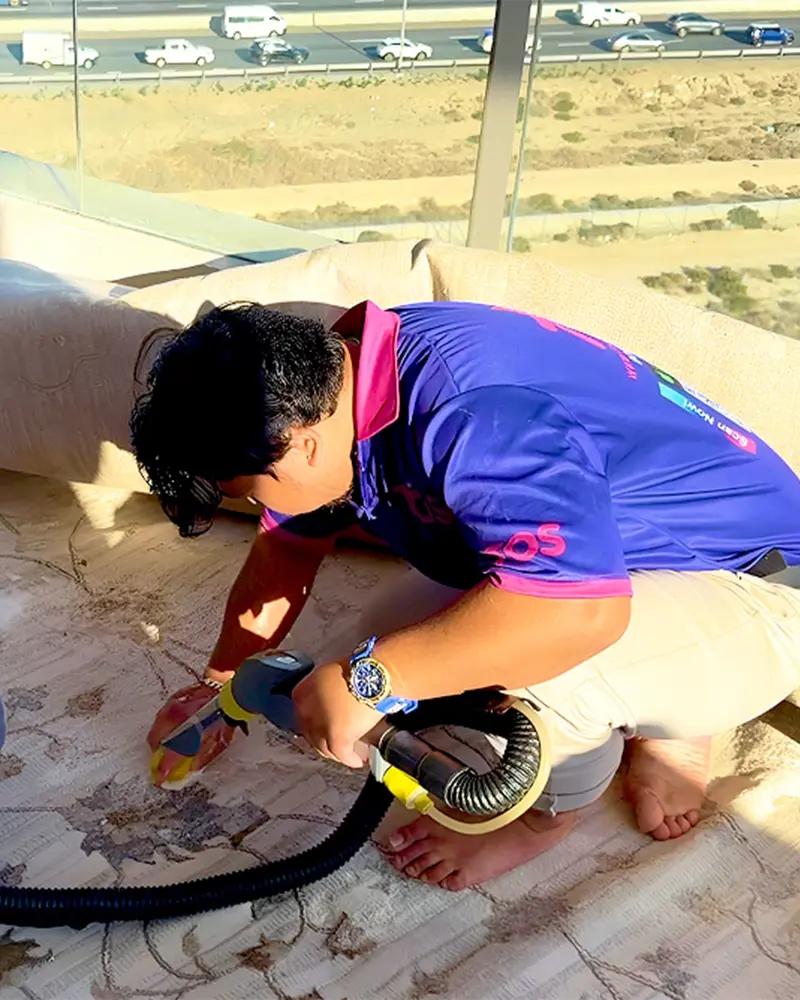 TopOne team cleaning a rug on a balcony