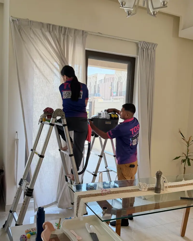 TopOne team cleaning curtains from ladders