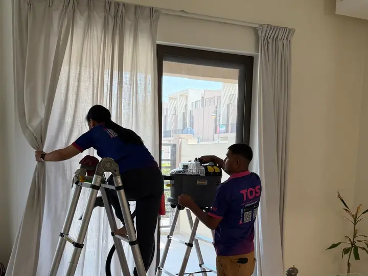 TopOne cleaner at a window with sheer and heavy curtains
